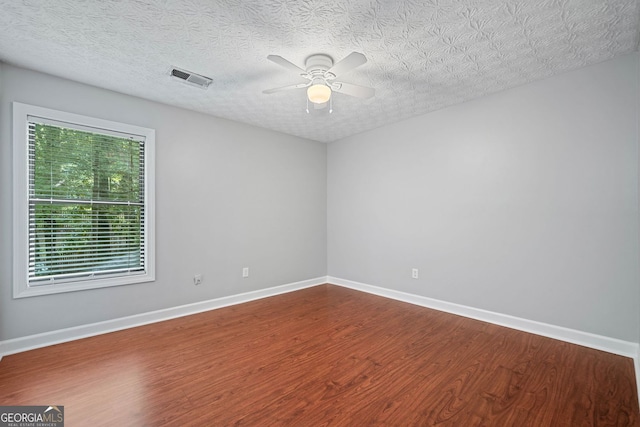 175 River Run, Roswell, GA 30075 - empty room with dark wood-style flooring, ceiling fan, baseboards, and a textured ceiling