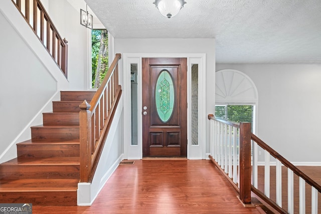 175 River Run, Roswell, GA 30075 - entryway with wood finished floors, stairway, and a textured ceiling