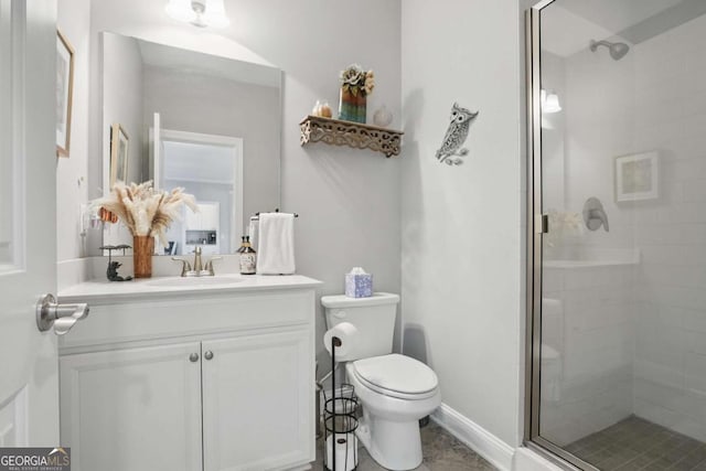 bathroom featuring a stall shower, toilet, and vanity