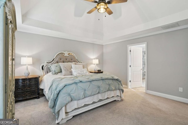 bedroom with carpet floors, a raised ceiling, baseboards, connected bathroom, and ornamental molding