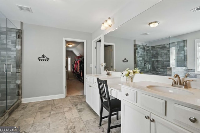 full bath with a stall shower, double vanity, a spacious closet, and baseboards
