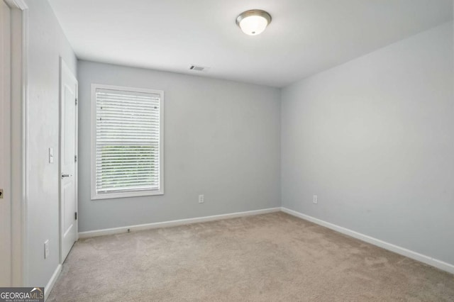 empty room with carpet flooring and baseboards