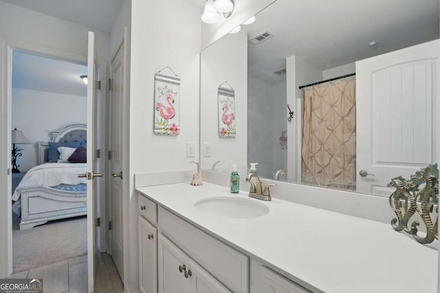 full bathroom featuring ensuite bath, vanity, and tile patterned floors
