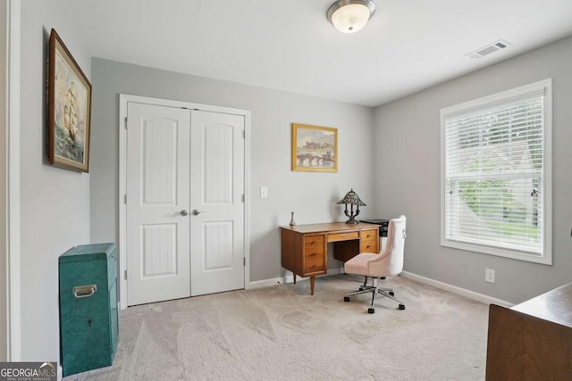 carpeted office space featuring baseboards