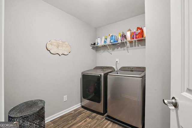 washroom with washing machine and clothes dryer, dark wood finished floors, and baseboards