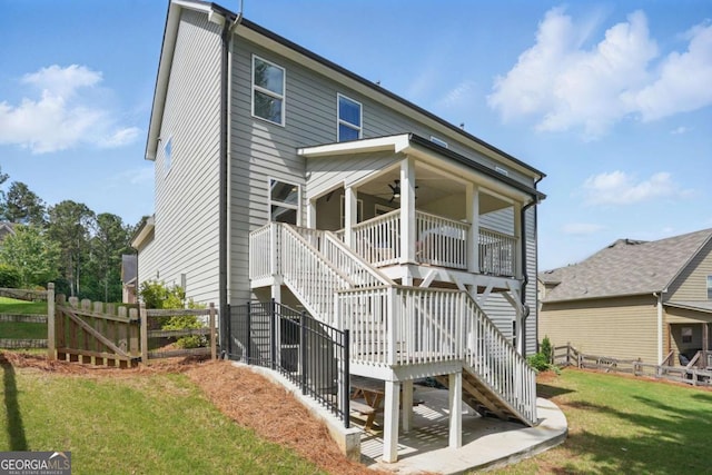 back of property with stairway and a ceiling fan