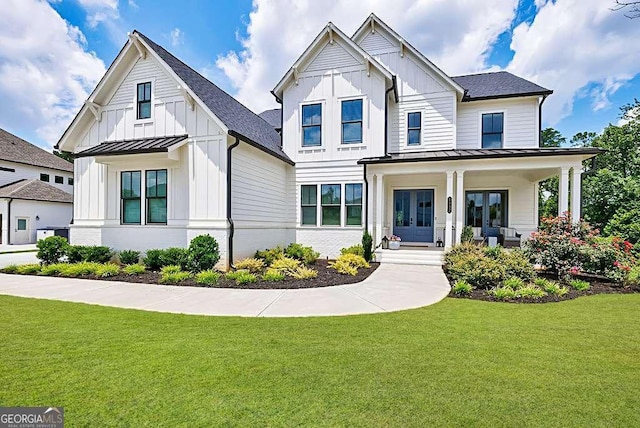 4992 Concert Ln, Marietta, GA 30066 - modern inspired farmhouse with board and batten siding, a standing seam roof, a front lawn, covered porch, and metal roof