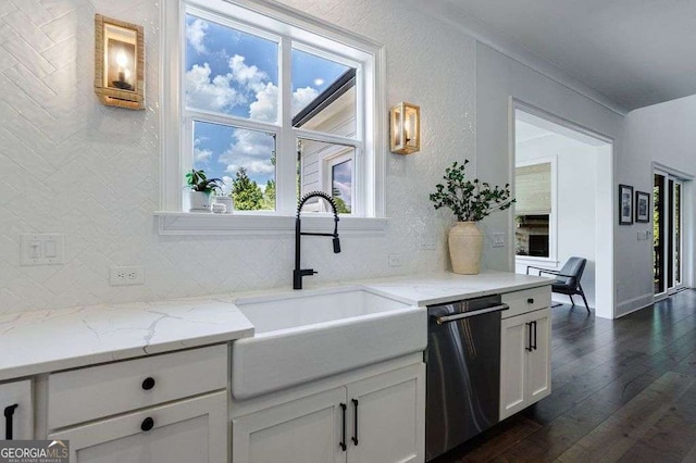 4992 Concert Ln, Marietta, GA 30066 - kitchen with stainless steel dishwasher, a sink, dark wood-style floors, white cabinetry, and light stone counters
