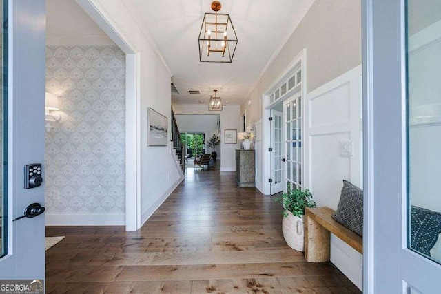 4992 Concert Ln, Marietta, GA 30066 - entryway featuring wood finished floors, baseboards, wallpapered walls, a chandelier, and ornamental molding