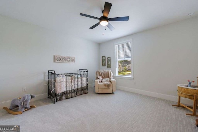 4992 Concert Ln, Marietta, GA 30066 - bedroom featuring carpet floors, baseboards, a crib, and ceiling fan