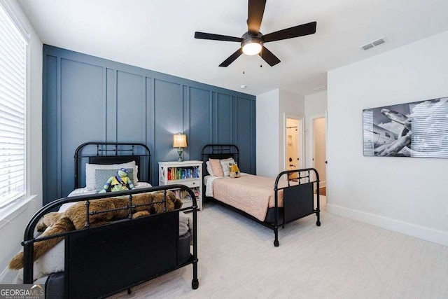 4992 Concert Ln, Marietta, GA 30066 - bedroom featuring a decorative wall, a ceiling fan, light carpet, and multiple windows