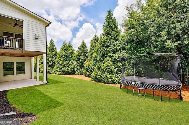 4992 Concert Ln, Marietta, GA 30066 - view of green lawn featuring a trampoline, a balcony, a patio area, and a ceiling fan