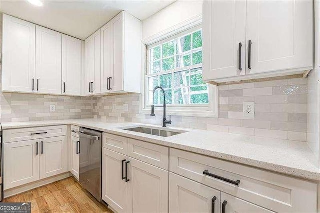 418 Mockingbird Ln, Smyrna, GA 30082 - kitchen with dishwasher, a sink, white cabinetry, light wood finished floors, and light stone counters