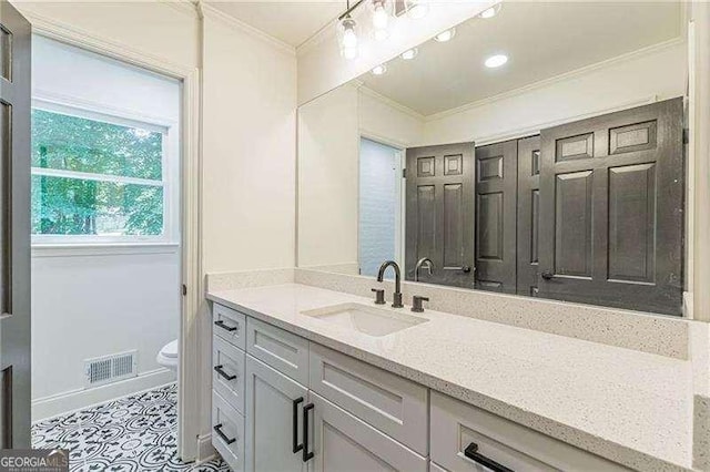 418 Mockingbird Ln, Smyrna, GA 30082 - bathroom featuring ornamental molding, toilet, vanity, and baseboards