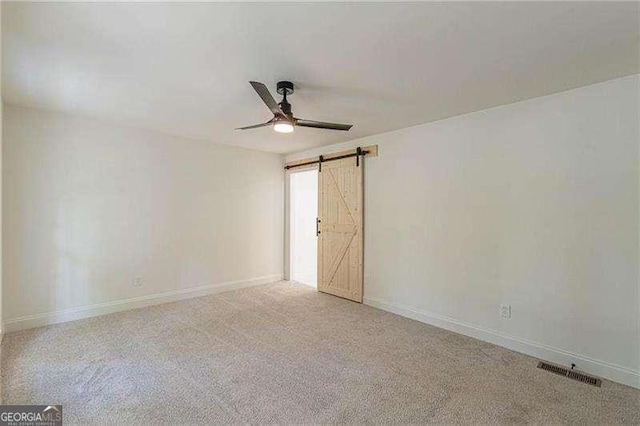 418 Mockingbird Ln, Smyrna, GA 30082 - spare room with a ceiling fan, a barn door, and baseboards