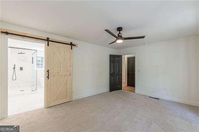 418 Mockingbird Ln, Smyrna, GA 30082 - carpeted empty room featuring a barn door, a ceiling fan, and baseboards