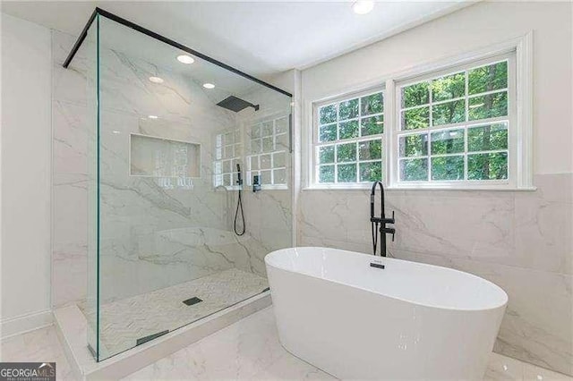 418 Mockingbird Ln, Smyrna, GA 30082 - bathroom featuring a marble finish shower, marble tiled floors, a freestanding tub, recessed lighting, and tile walls