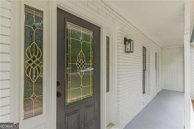 418 Mockingbird Ln, Smyrna, GA 30082 - view of exterior entry with a porch and brick siding