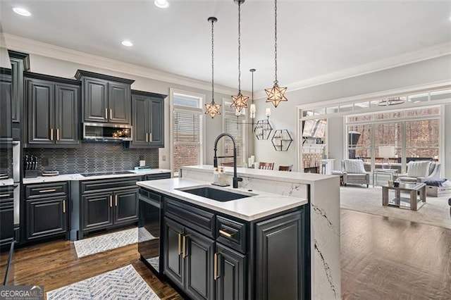 1525 Camden Cove Dr, Cumming, GA 30040 - kitchen with a sink, dishwasher, stainless steel microwave, light countertops, and a center island with sink