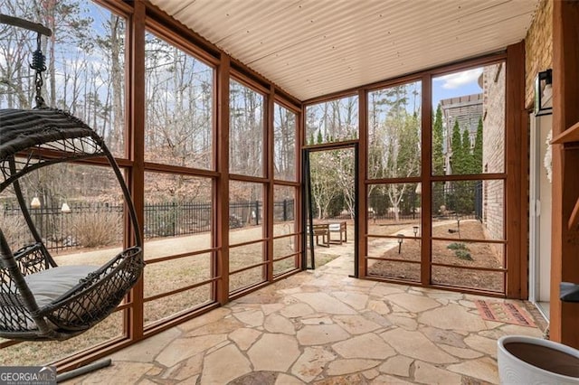 1525 Camden Cove Dr, Cumming, GA 30040 - unfurnished sunroom with floor to ceiling windows and stone floors