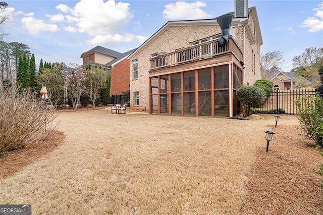 1525 Camden Cove Dr, Cumming, GA 30040 - rear view of property with a balcony, fence, brick siding, a chimney, and a sunroom