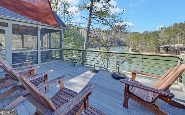 wooden deck with a sunroom and a water view