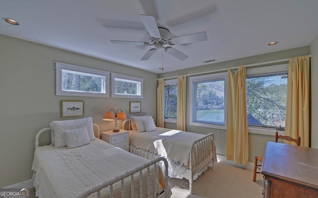 carpeted bedroom featuring baseboards, recessed lighting, and a ceiling fan