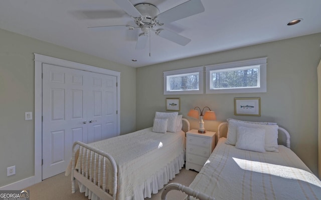 bedroom featuring ceiling fan, light colored carpet, and baseboards