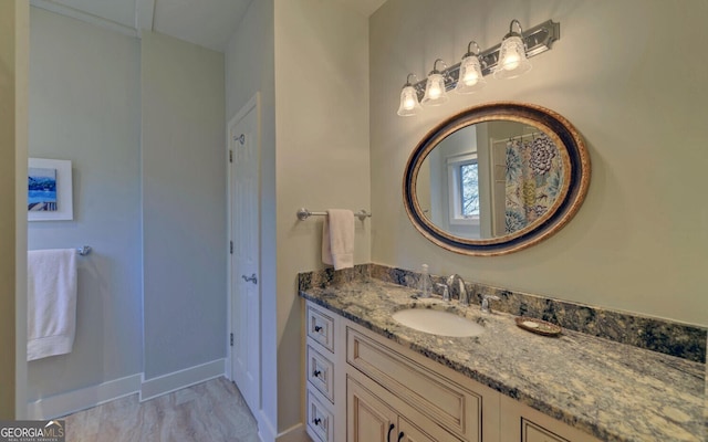 bathroom with vanity and baseboards