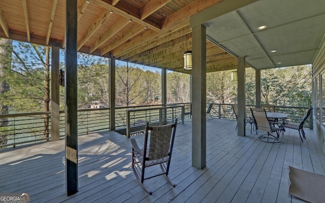wooden terrace featuring outdoor dining area