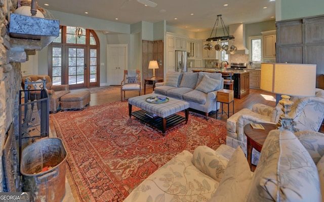 living room with light wood-style floors and recessed lighting