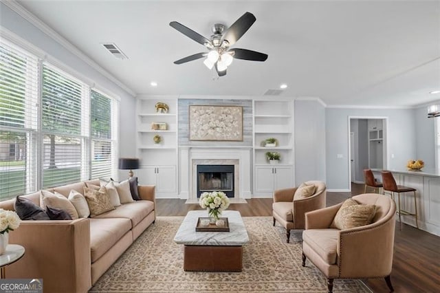 3826 Baxley Village Trl, Suwanee, GA 30024 - living area with ornamental molding, wood finished floors, ceiling fan, a high end fireplace, and recessed lighting