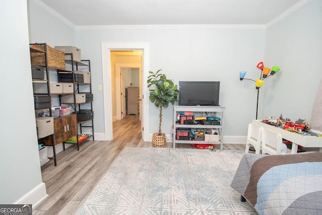 bedroom featuring crown molding, wood finished floors, and baseboards