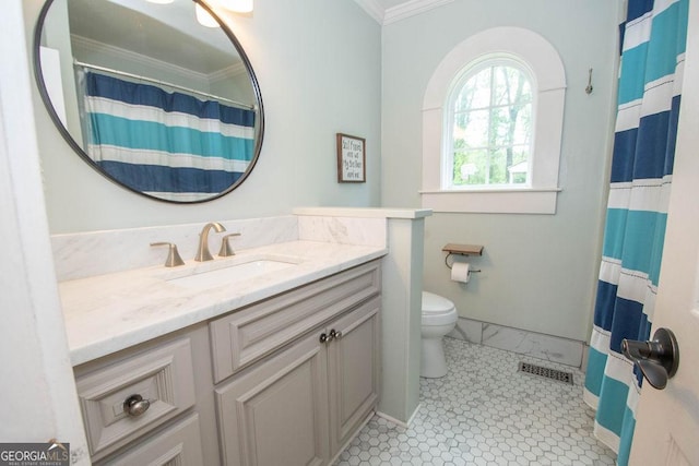 full bathroom with ornamental molding, toilet, vanity, and curtained shower
