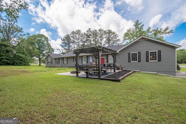 back of property with a pergola, a patio area, and a lawn