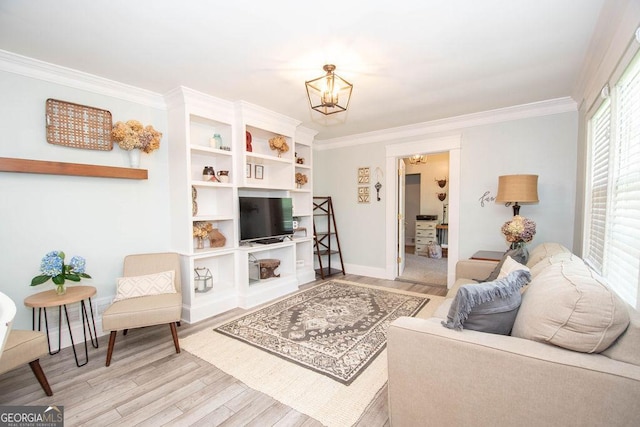 living area featuring a chandelier, wood finished floors, crown molding, and baseboards