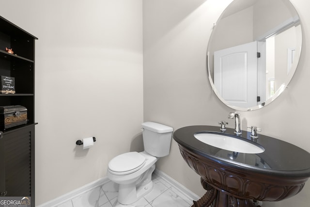 1181 Gateview Dr, Lawrenceville, GA 30046 - bathroom featuring marble look tiles, baseboards, toilet, and a sink