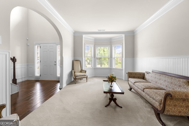 1181 Gateview Dr, Lawrenceville, GA 30046 - living room with arched walkways, a wainscoted wall, ornamental molding, and hardwood / wood-style floors
