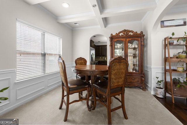 1181 Gateview Dr, Lawrenceville, GA 30046 - dining area featuring arched walkways, coffered ceiling, beam ceiling, a wainscoted wall, and a decorative wall
