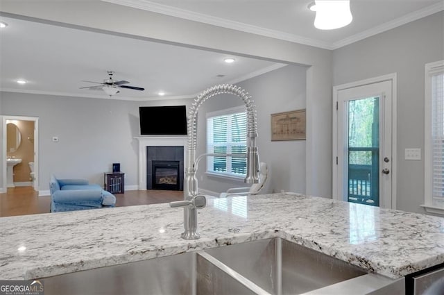 541 Glen Abbey Cir, Mableton, GA 30126 - kitchen featuring plenty of natural light, a tiled fireplace, light stone countertops, crown molding, and recessed lighting