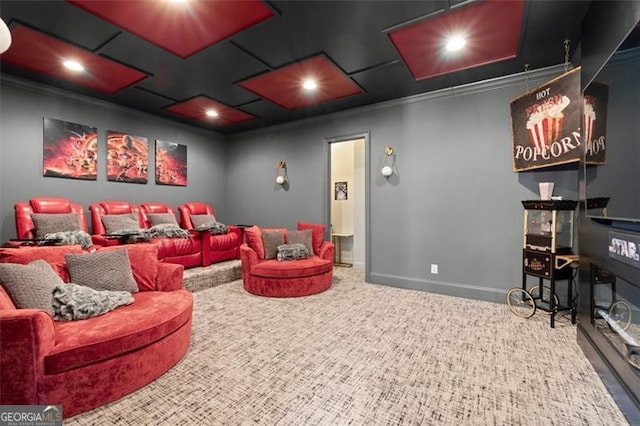 carpeted cinema featuring crown molding and baseboards