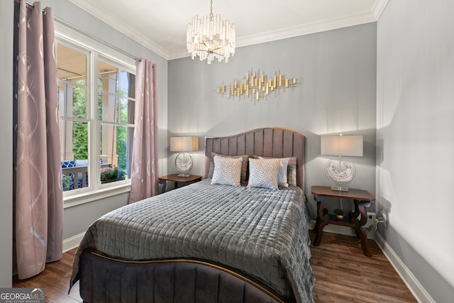bedroom with a chandelier, wood finished floors, baseboards, and ornamental molding