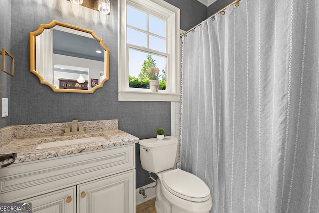 bathroom featuring toilet, vanity, wallpapered walls, and a shower with shower curtain