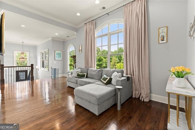 living room featuring wood finished floors, baseboards, crown molding, and recessed lighting