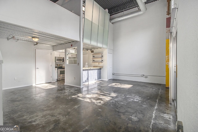 195 Arizona Ave Unit 179, Atlanta, GA 30307 - unfurnished living room with concrete flooring and a high ceiling