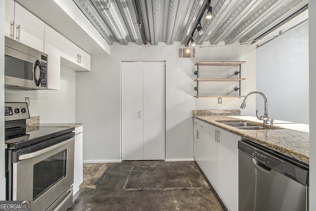 195 Arizona Ave Unit 179, Atlanta, GA 30307 - kitchen with appliances with stainless steel finishes, a sink, light stone counters, open shelves, and white cabinetry