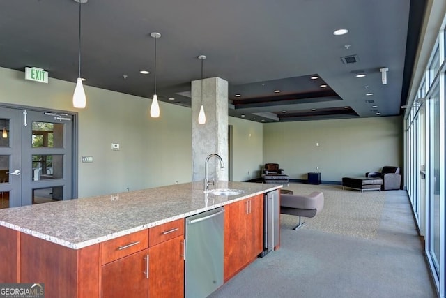 195 Arizona Ave Unit 179, Atlanta, GA 30307 - kitchen featuring a sink, open floor plan, carpet flooring, stainless steel dishwasher, and decorative light fixtures