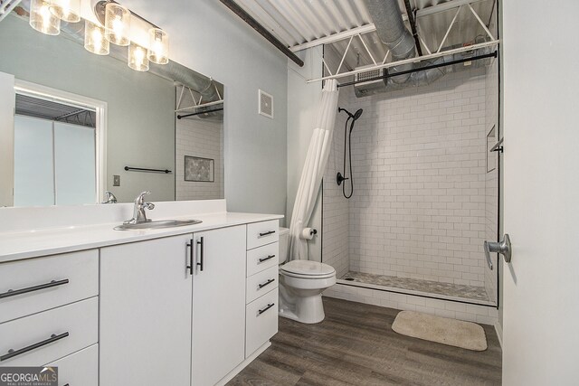 195 Arizona Ave Unit 179, Atlanta, GA 30307 - bathroom featuring toilet, a stall shower, vanity, and wood finished floors