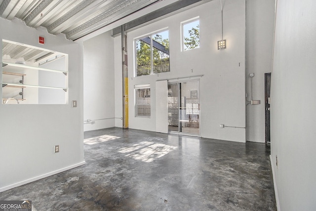 195 Arizona Ave Unit 179, Atlanta, GA 30307 - unfurnished living room featuring concrete floors and a high ceiling