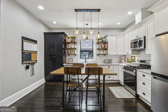 1211 Mortimer Pl SE, Atlanta, GA 30317 - kitchen with appliances with stainless steel finishes, open shelves, baseboards, tasteful backsplash, and dark wood-style flooring